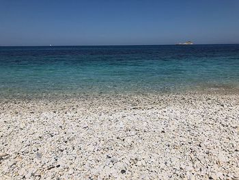 Scenic view of sea against clear blue sky