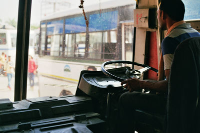 Man driving bus in city