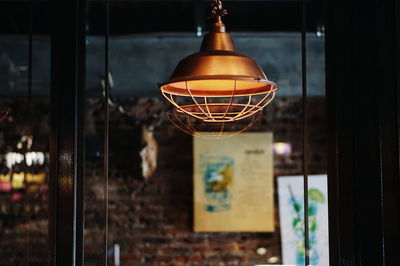 Close-up of illuminated light hanging from ceiling