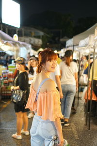 Group of people walking on street in city