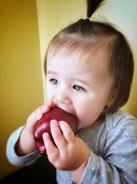 Close-up portrait of cute girl eating food