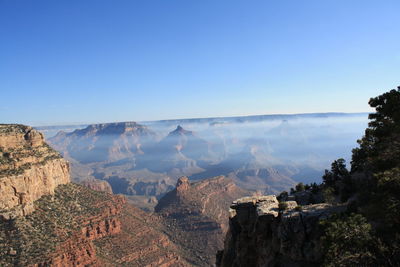 Scenic view of rocky mountains against clear blue sky at grand canyon national park