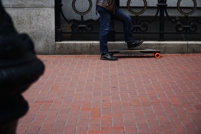 Low section of man walking on footpath