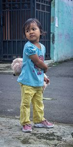 Side view of boy standing on street