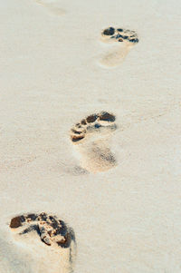 High angle view of footprints in sand at beach