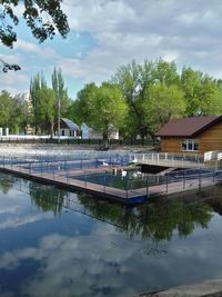 View of swimming pool by lake against sky