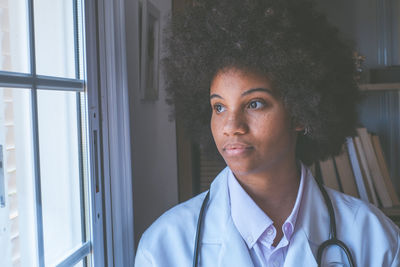 Doctor looking through window at clinic