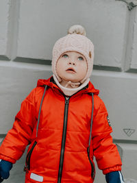 Portrait of boy standing against wall