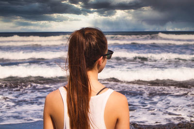 Rear view of woman looking at sea shore