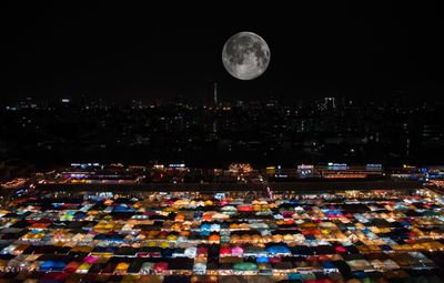 High angle view of city lit up at night