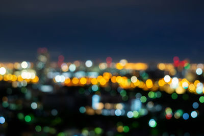 Defocused image of illuminated city at night
