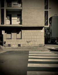 Empty road by building