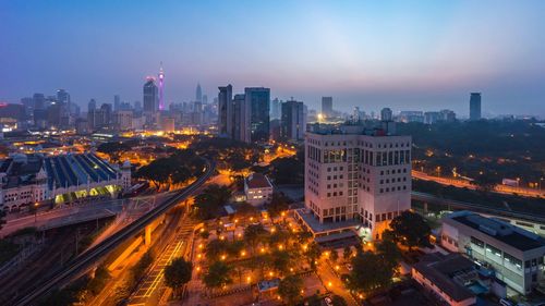 Illuminated cityscape at sunset