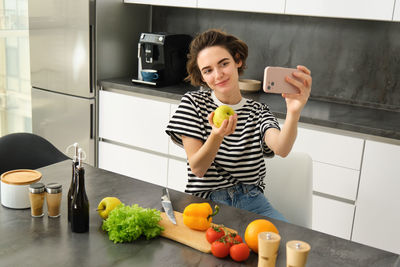 High angle view of woman holding food at home