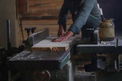 Midsection of man working in kitchen