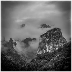 Scenic view of rock formation amidst fog