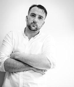 Portrait of mid adult man against white background