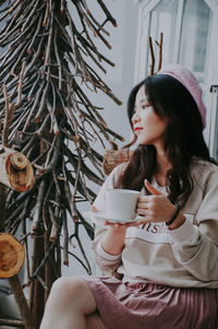 Young woman drinking coffee cup