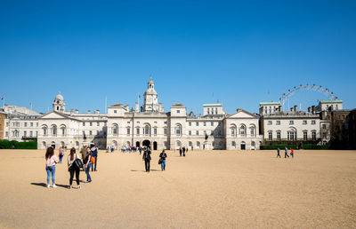 Group of people on building against blue sky