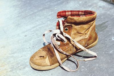 High angle view of shoes on abandoned floor