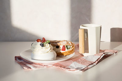 Sweet desserts with strawberry, blueberry and mint on white table. continental breakfast with coffee