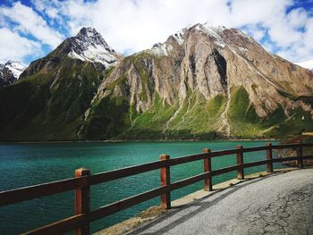 Scenic view of sea and mountains against sky