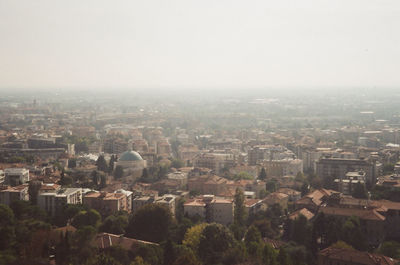 High angle view of city buildings against clear sky