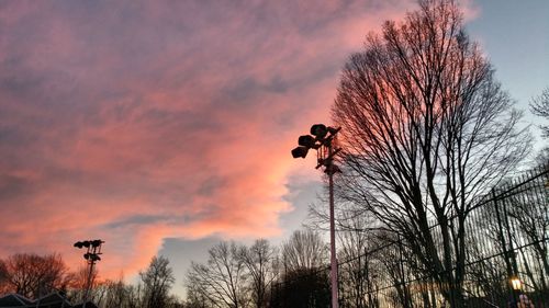 Silhouette of bare tree against cloudy sky