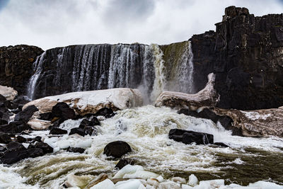 Scenic view of waterfall against rocks