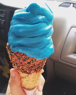 Close-up of hand holding ice cream cone