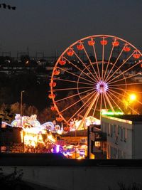 Illuminated ferris wheel at night