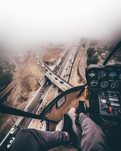 Midsection of man at airplane against sky