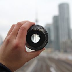 Close-up of hand holding lens