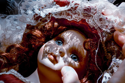 Close-up portrait of doll face with red hair