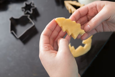 Cropped image of hand holding cookies