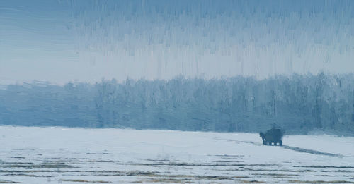 Snow covered landscape against sky