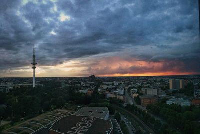 Cityscape against cloudy sky