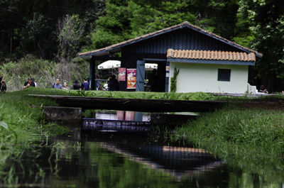 View of cottage by lake against building