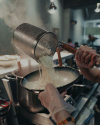 Midsection of person preparing food in kitchen