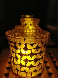 Close-up of illuminated lamp on table