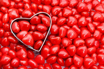 Directly above shot of pastry cutter with red heart shape food