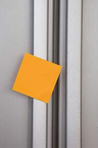 Close-up of blank adhesive note on refrigerator