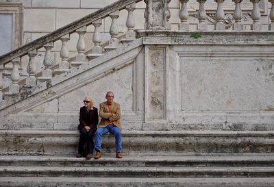 Full length of woman standing by railing