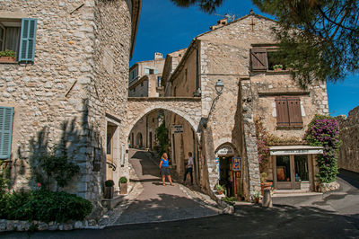 People on street amidst buildings in town