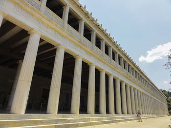 Woman standing against stoa of attalos