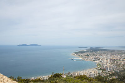 High angle view of sea and city against sky