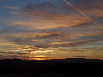 Scenic view of silhouette mountains against sky during sunset