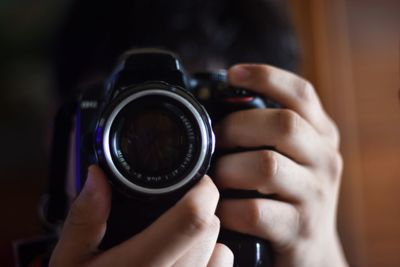Midsection of woman photographing camera