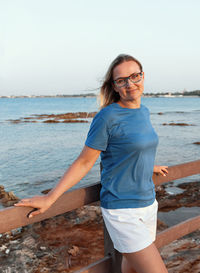 Young woman standing at beach