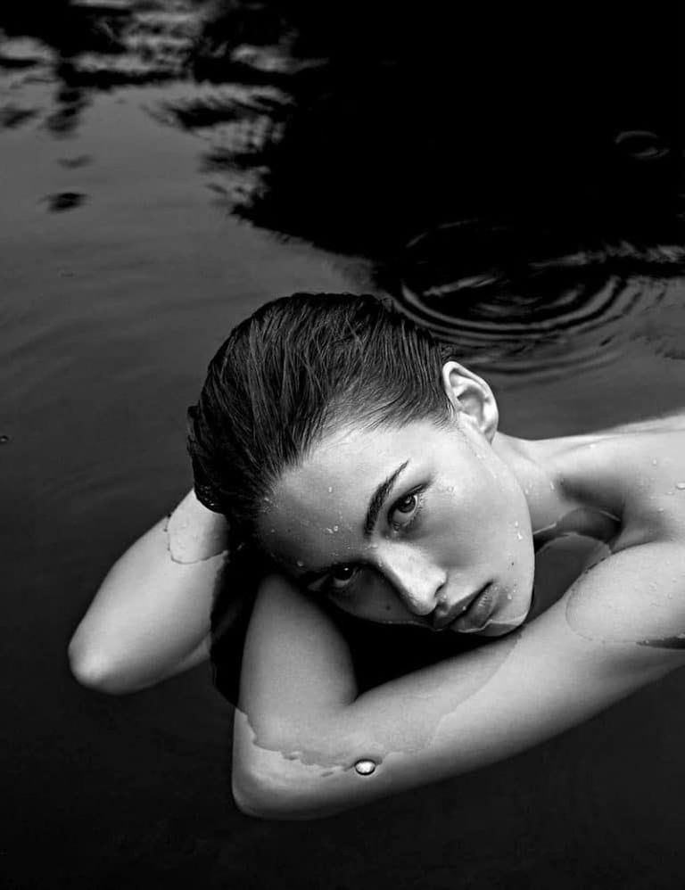 HIGH ANGLE PORTRAIT OF WOMAN LYING ON SWIMMING POOL